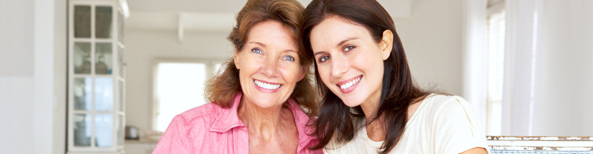 Adult mother and daughter smiling